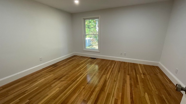 spare room with hardwood / wood-style floors