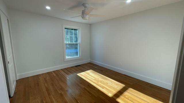 spare room with ceiling fan and hardwood / wood-style floors