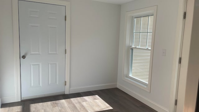 spare room featuring dark wood-type flooring