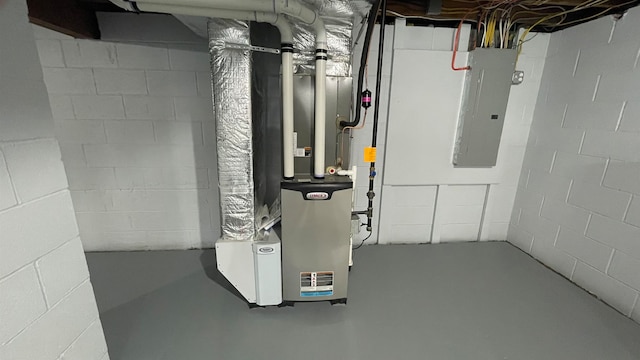 utility room featuring electric panel and heating unit