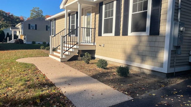 view of side of home with a lawn