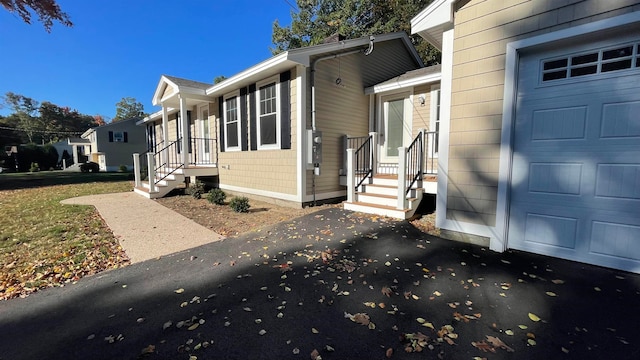 view of property exterior featuring a yard and a garage