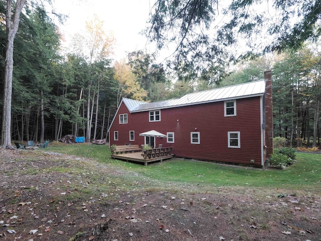 back of house featuring a yard and a wooden deck