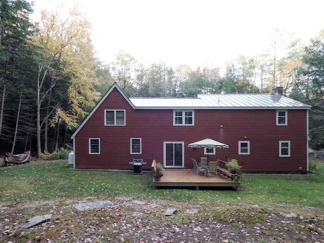 back of house with a yard and a deck