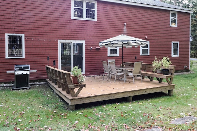 back of property with a wooden deck and a lawn