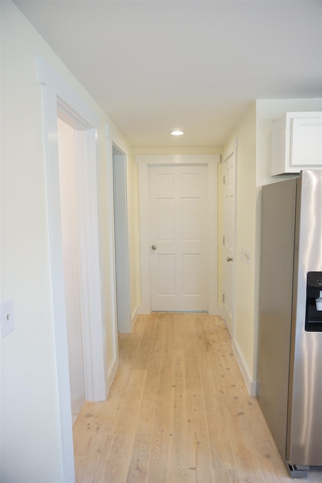 corridor with light hardwood / wood-style flooring