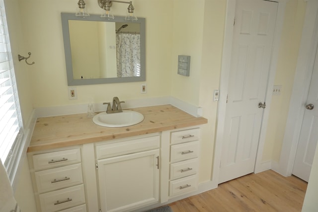 bathroom with vanity and wood-type flooring