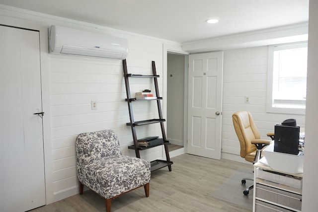 office space with light wood-type flooring and an AC wall unit