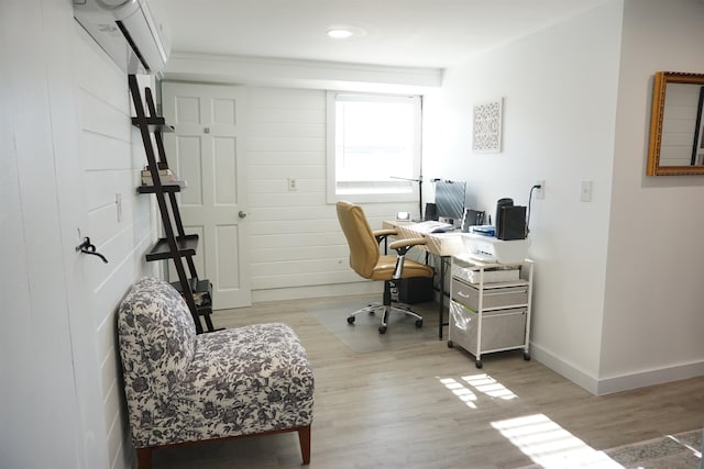 office featuring a wall mounted air conditioner and light wood-type flooring