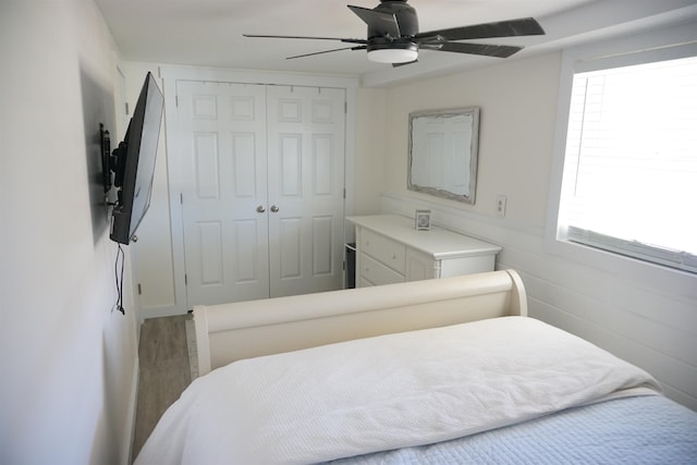 bedroom featuring hardwood / wood-style floors, a closet, and ceiling fan