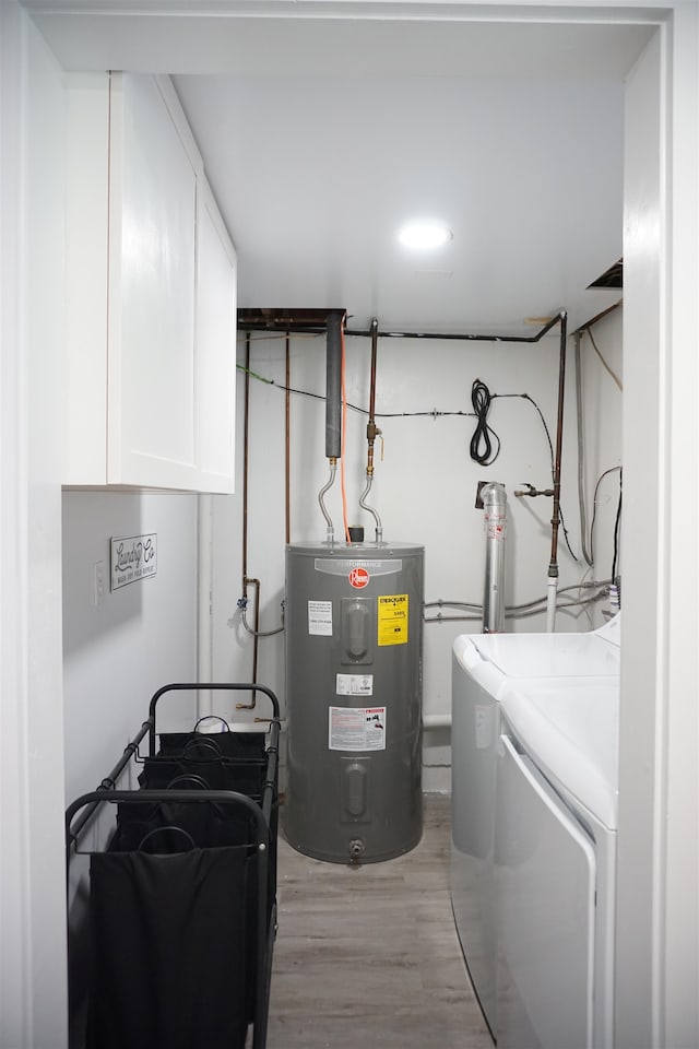 utility room with washer and clothes dryer and electric water heater