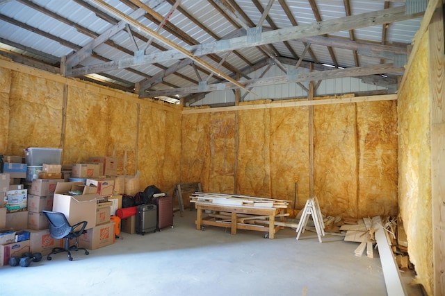 misc room with concrete flooring and lofted ceiling