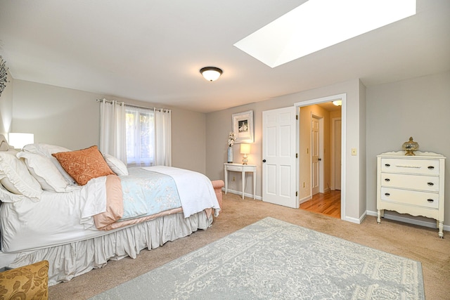 bedroom featuring light colored carpet and a skylight