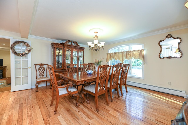 dining area featuring ornamental molding, a baseboard radiator, a chandelier, and light hardwood / wood-style flooring