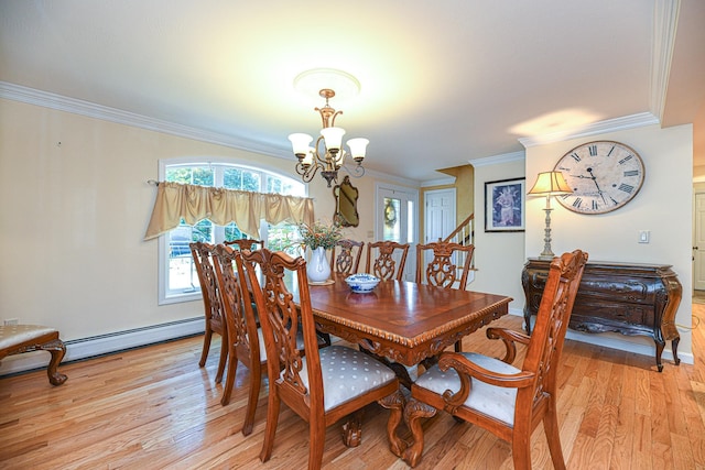 dining area with ornamental molding, light wood-type flooring, and a chandelier