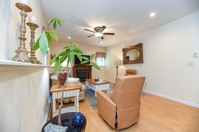 sitting room with ceiling fan and light hardwood / wood-style flooring