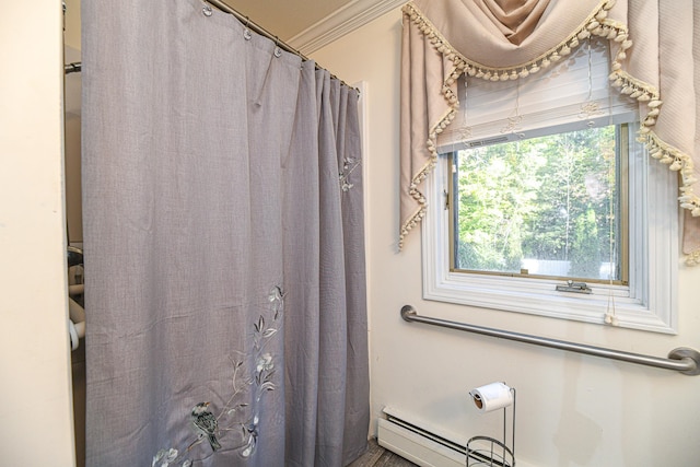 bathroom featuring ornamental molding and curtained shower