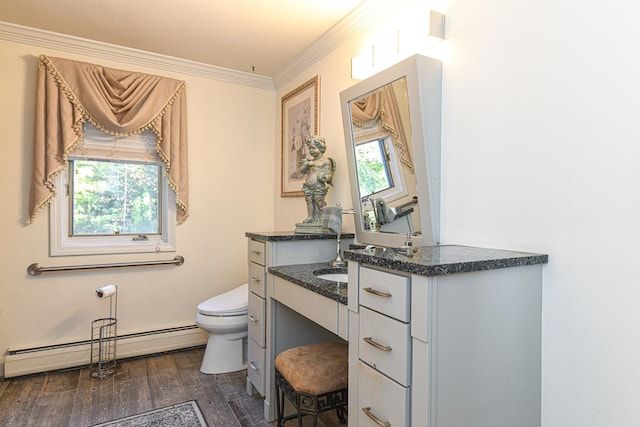 bathroom with vanity, hardwood / wood-style flooring, crown molding, a baseboard radiator, and toilet