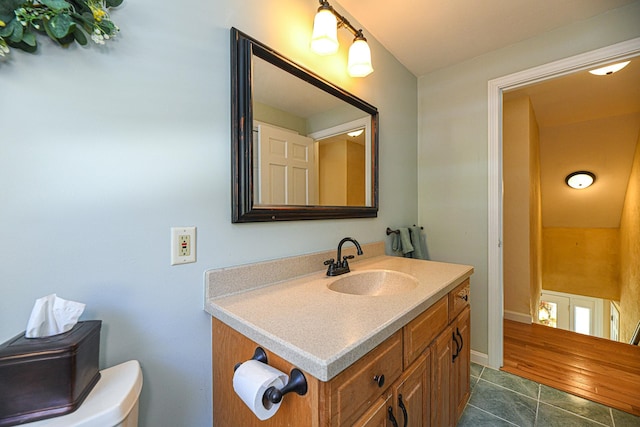 bathroom with tile patterned flooring, vanity, and toilet