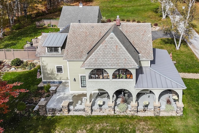 rear view of house featuring a yard and a patio