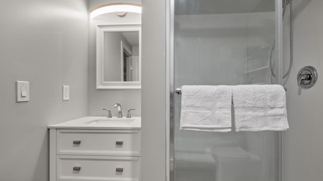 bathroom featuring vanity, a shower, and toilet