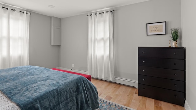 bedroom featuring light hardwood / wood-style flooring and baseboard heating