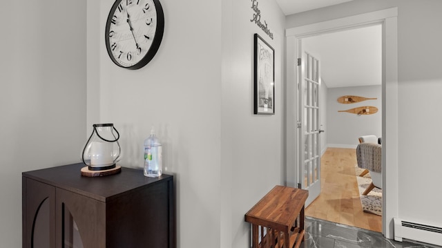 hall with hardwood / wood-style floors and a baseboard radiator