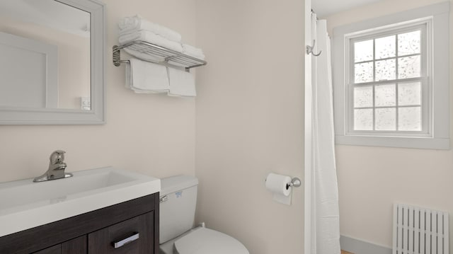 bathroom featuring vanity, radiator, and toilet