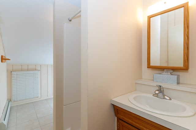 bathroom featuring baseboard heating, tile patterned floors, and vanity