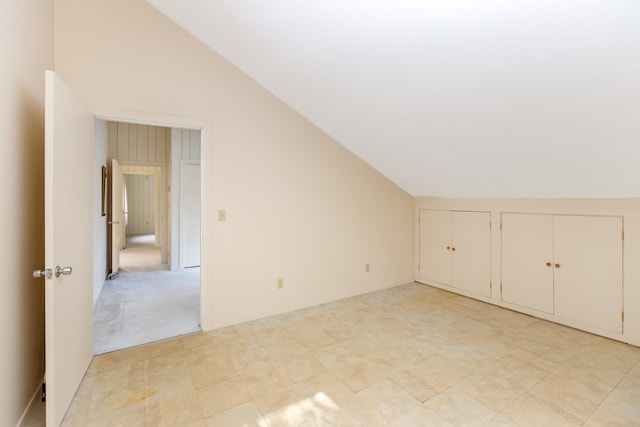 additional living space with lofted ceiling and light colored carpet