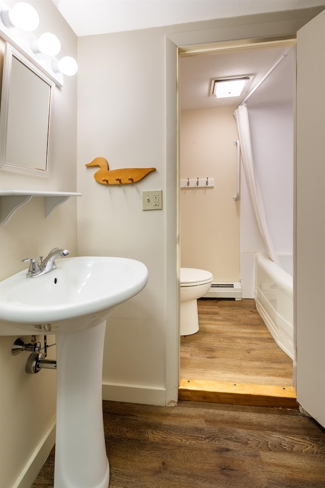 bathroom featuring wood-type flooring, a baseboard radiator, toilet, and shower / tub combo with curtain