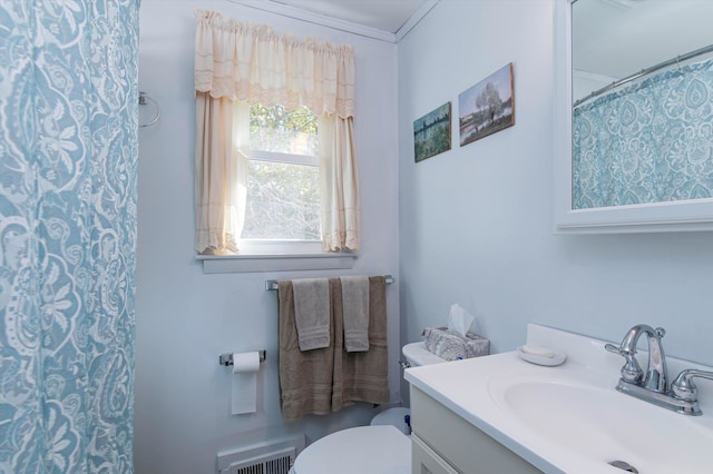 bathroom featuring crown molding, vanity, walk in shower, and toilet