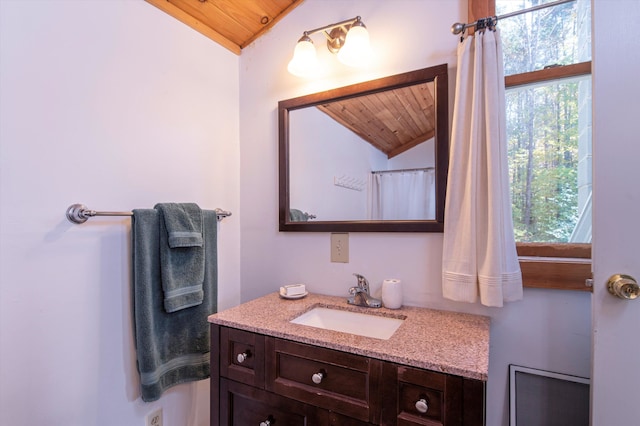 bathroom featuring wooden ceiling, vaulted ceiling, and a healthy amount of sunlight