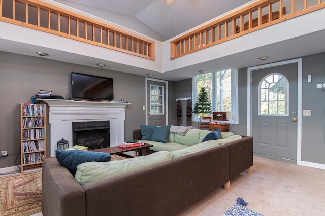 carpeted living room featuring high vaulted ceiling