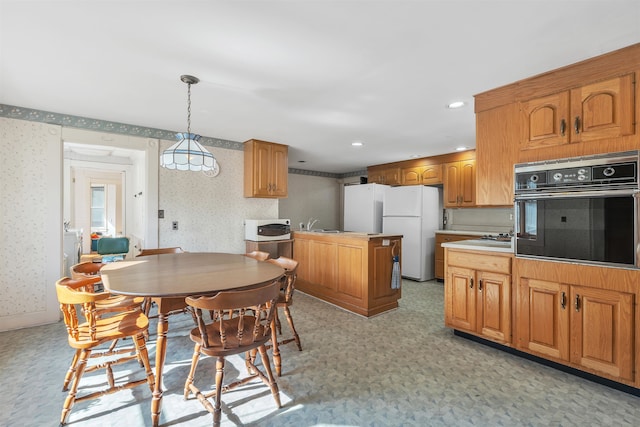 kitchen with pendant lighting and white appliances