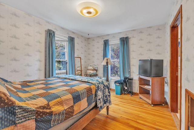 bedroom featuring hardwood / wood-style flooring and multiple windows