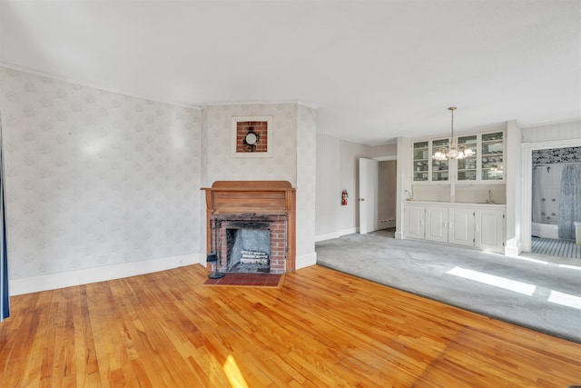 unfurnished living room featuring hardwood / wood-style floors and a notable chandelier