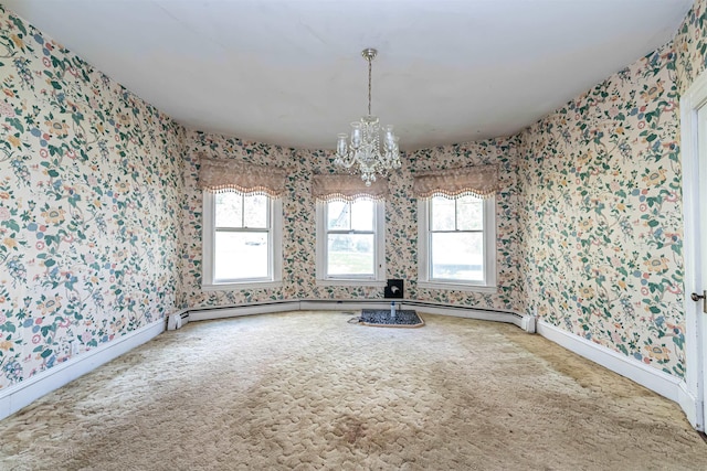 unfurnished dining area featuring wallpapered walls, plenty of natural light, and a notable chandelier