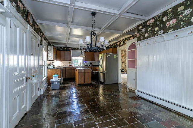 kitchen featuring an inviting chandelier, coffered ceiling, freestanding refrigerator, a kitchen island, and baseboard heating