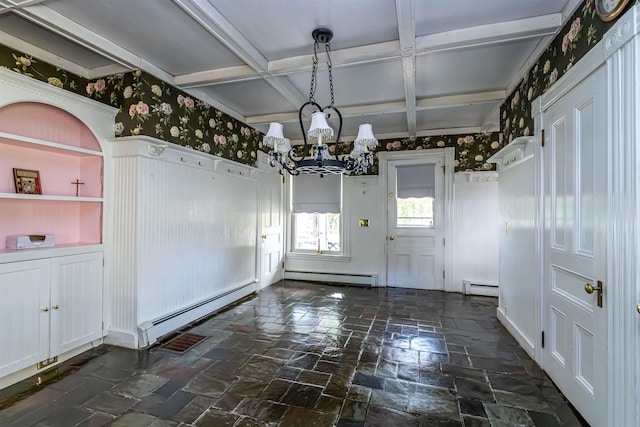 unfurnished dining area featuring a baseboard heating unit, stone tile flooring, and a notable chandelier