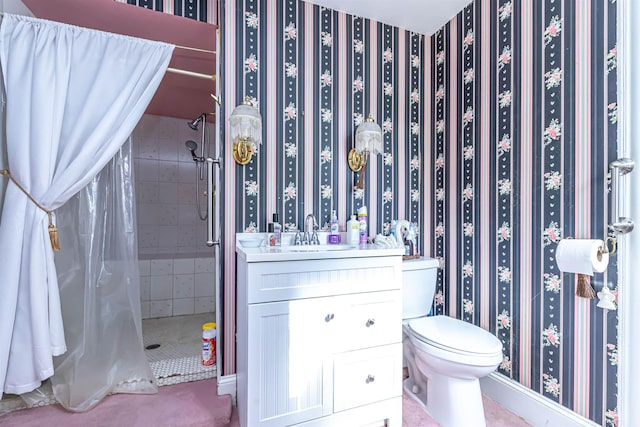 bathroom featuring vanity, a shower stall, and toilet