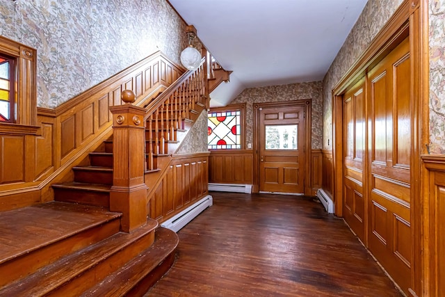 mudroom with a baseboard heating unit, wallpapered walls, wainscoting, and dark wood finished floors