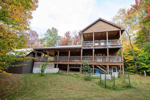 back of property featuring a lawn and a deck