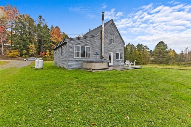 rear view of house featuring a yard and a deck