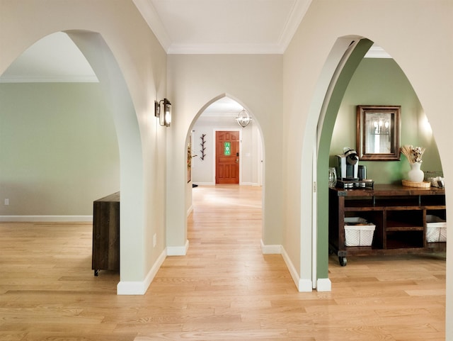 hallway with light wood-type flooring and crown molding