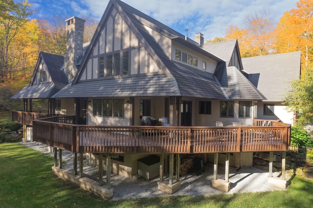 rear view of property featuring a deck