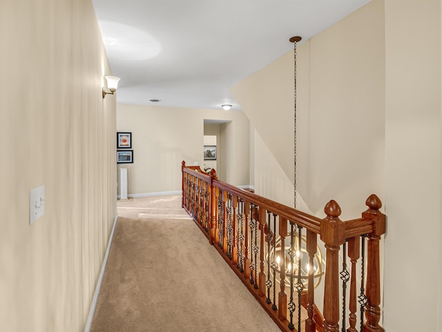 hallway featuring light colored carpet