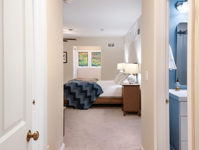 carpeted bedroom featuring ensuite bath