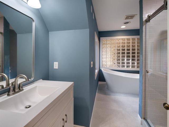 bathroom with vanity and independent shower and bath