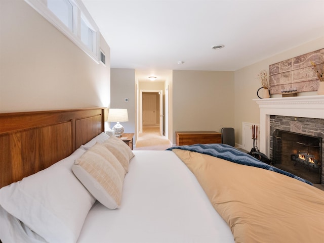 carpeted bedroom with a fireplace